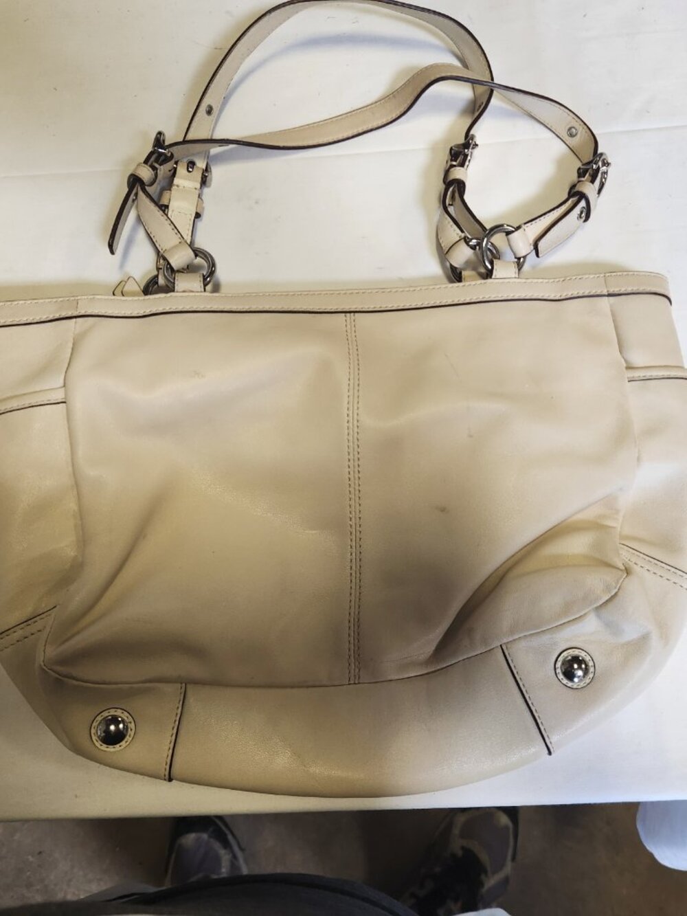 Coach Gallery East West Ivory Leather Tote features silver-toned accents.